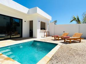 a swimming pool in the backyard of a house at U paradisu Villas - Villa 1BR - Private Pool in Jambiani