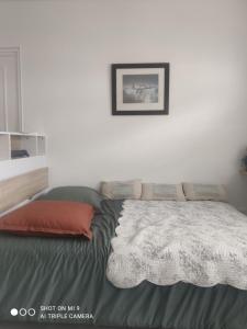 a bedroom with a bed with a blanket on it at La Suite by Nath in Calais