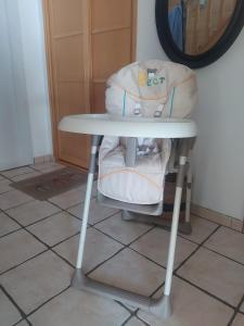 a white chair with a table and a mirror at La Suite by Nath in Calais