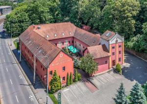 an overhead view of a large pink house at Hotel STARÝ PIVOVAR in Prague +34 photos