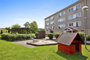 a building with a play structure in a yard at One Large Room with 3 single beds in Gothenburg +18 photos