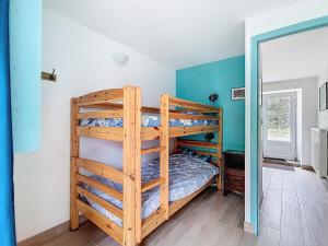 a bedroom with two bunk beds in a room at La Mainerie in Jobourg