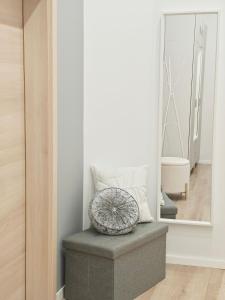 a mirror sitting on top of a bench in a room at Vibe City Apartment in Kecskemét