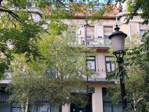 a building with a street light in front of it at Vibe City Apartment in Kecskemét