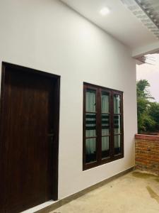 an empty room with a door and a window at Wilpattu Nuga Lodge in Pahala Maragahawewa +15 photos