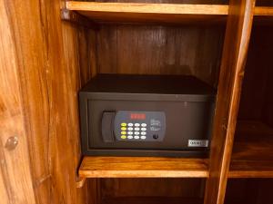 a microwave oven sitting inside of a wooden cabinet at Raja Beach Hotel in Balapitiya