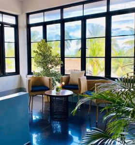 a lobby with chairs and a table and windows at Hotel Bijoux in Plaridel +30 photos