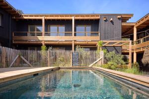 a house with a swimming pool in front of a house at Kaze Océan, The Originals Relais in Cap-Ferret