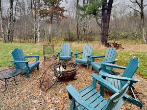 a group of blue chairs sitting around a fire pit at Buzzy Bee Lodge in McHenry