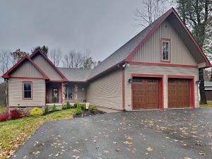 a house with a garage at Buzzy Bee Lodge in McHenry