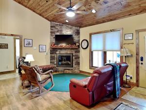 a living room with a fireplace and a couch and chairs at Buzzy Bee Lodge in McHenry +68 photos