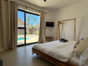 a bedroom with a bed and a large window at U Paradisu Villas- 2 private pool villas in Kibigija +47 photos