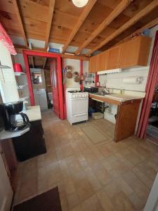 a kitchen with a counter and a stove top oven at SWALLOW - LIMIT 4 cottage in North Sebago