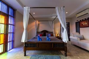 a bedroom with a bed with blue teddy bears on it at Khaoyai Nature Life & Tour Resort in Nong Nam Daeng +42 photos