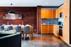 a kitchen and dining room with a table and chairs at Résidence Montana Caron by Village Montana in Val Thorens +3 photos
