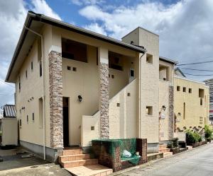 a house with a building on the side of it at セレーナ南福岡 in Fukuoka