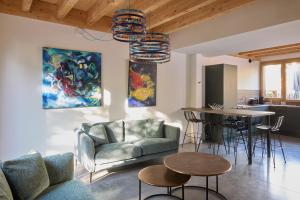 a living room with a couch and a table at Kaze Océan, The Originals Relais in Cap-Ferret