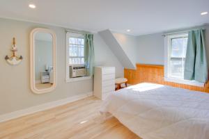 a bedroom with a white bed and a mirror at Lake-View Spofford Apartment w/ Shared Dock! in Spofford