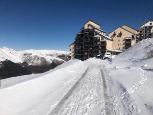 a snow covered road in front of a building at Le refuge 66 in Saint-Aventin +14 photos