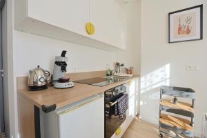 a kitchen with a sink and a counter top at La Campus Douillet in Saint-Étienne