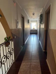 a hallway of a building with a staircase and a window at Готель Брамка in Kovelʼ