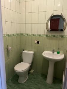 a bathroom with a toilet and a sink at Готель Брамка in Kovelʼ