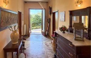 a hallway with a table and a dresser in a room at Pet Friendly Home In Larciano With Swimming Pool in Larciano