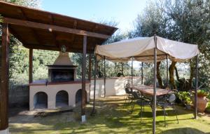 a patio with a table and an umbrella and a fireplace at Pet Friendly Home In Larciano With Swimming Pool in Larciano +12 photos