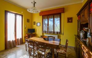 a dining room with a wooden table and chairs at Pet Friendly Home In Larciano With Swimming Pool in Larciano