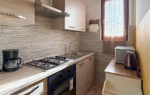a small kitchen with a stove and a sink at Pet Friendly Home In Larciano With Swimming Pool in Larciano
