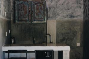a kitchen with a sink and a cabinet at Birds of Paradise Surf and Yoga Boutique & Retreat in Weligama +50 photos