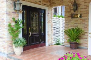 a front door of a house with potted plants at La Isla Tasse in Yakushima