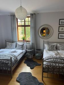 a bedroom with two beds and a window at Willa Józefina - Mini Spa & Family Fun in Szklarska Poręba