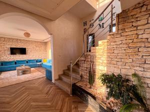 a lobby with a blue couch and a stone wall at Villa Sunset Moulay in Beni Balla