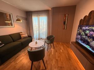 a living room with a couch and a fish tank at Devana Premium Apartments by CHORS in Nivy