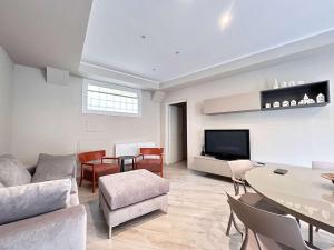 a living room with a couch and a table at Homeby, Modern Loft Pisa in Pisa