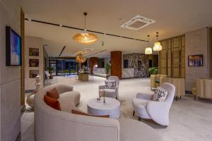 a lobby with couches and chairs and a table at Aletris Deluxe Hotel & SPA in Side