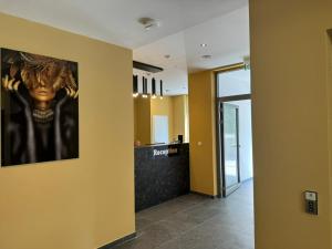a hallway with a painting of a head on the wall at Lillys Hotel 