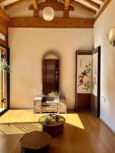 a living room with a table and a mirror at seoul hanok stay moonee in Seoul