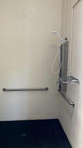 a bathroom with a toilet with two hand rails at Lakefront Cabin Rental in Bradenton, Florida in Eastgate