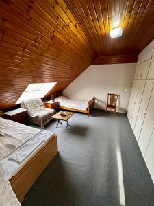 a room with two beds and a wooden ceiling at White House in Ternat