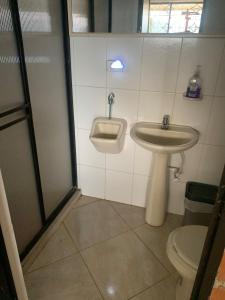 a bathroom with a sink and a toilet at Finca Panoramica in Barbosa +17 photos