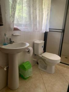 a bathroom with a sink and a toilet at Finca Panoramica in Barbosa