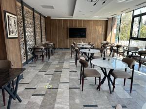 a restaurant with tables and chairs and a flat screen tv at İdil Haznedar Otel in İdil +35 photos