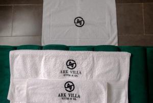 a couple of white towels on top of a bed at Ark Villa Hotel & Spa in Lekki