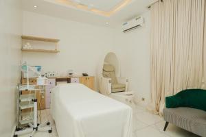 a hospital room with a bed and a chair at Ark Villa Hotel & Spa in Lekki