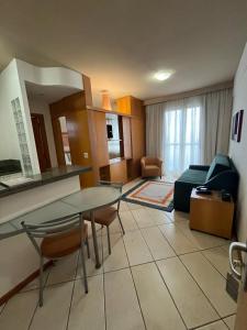 a living room with a table and chairs and a couch at Vila da Serra Differential in Nova Lima