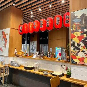 a restaurant with red lanterns hanging above a counter at Apartemen OSAKA Riverview PIK2 Studio By GPI in Rawalumpang
