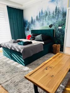 a bedroom with a bed and a wooden table at Twoje prywatne SPA - jacuzzi, sauna, tężnia solankowa in Kraków +14 photos