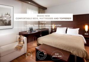 a bedroom with a bed and a desk with a clock at Comfort Hotel Olomouc Centre in Olomouc